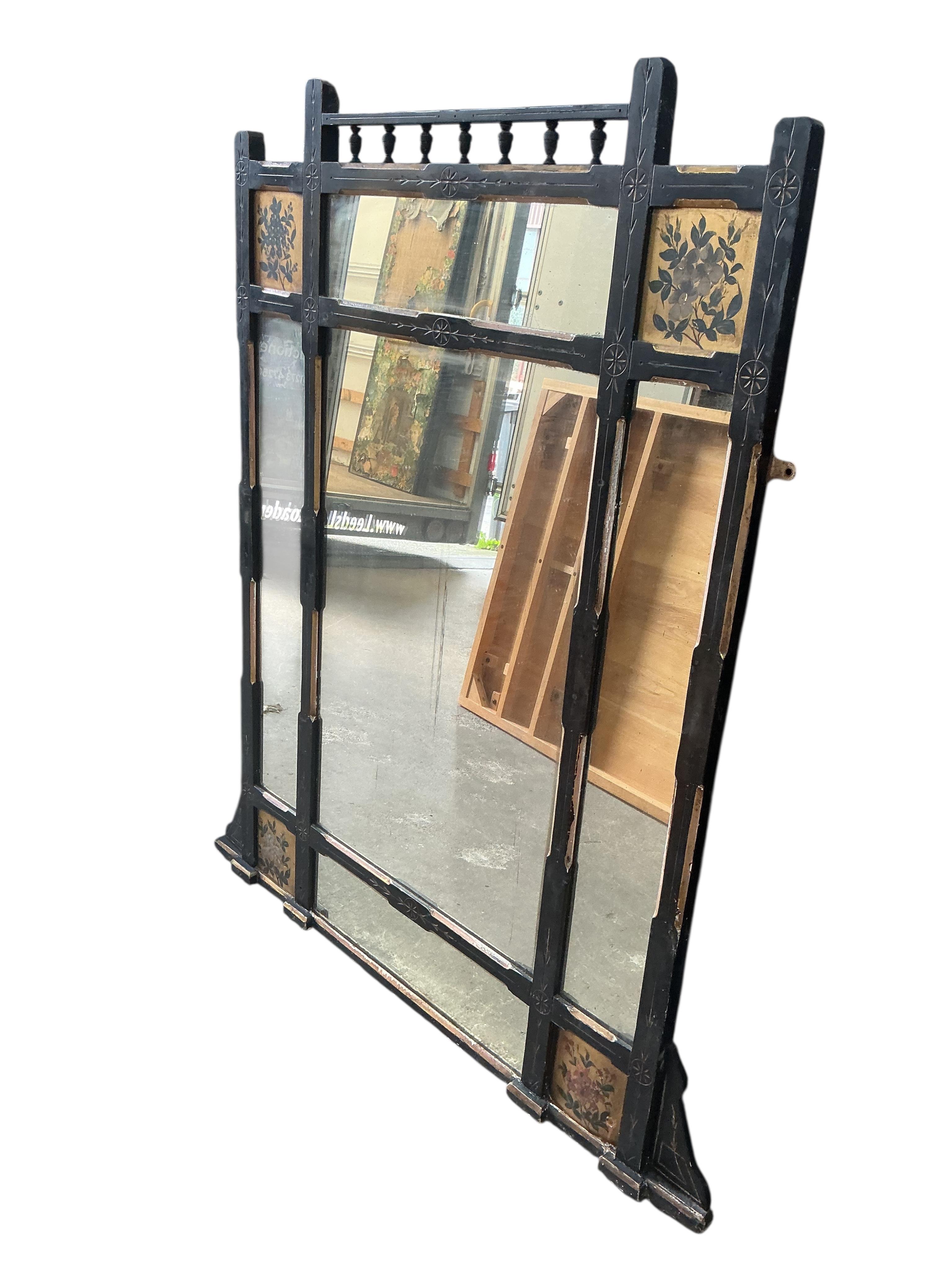 A late Victorian Aesthetic movement part ebonised painted overmantel mirror, width 94cm, height 134cm